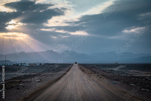 Fototapeta Sunset through the clouds in Ahmed Ela village in the Danakil depression, Ethiopia