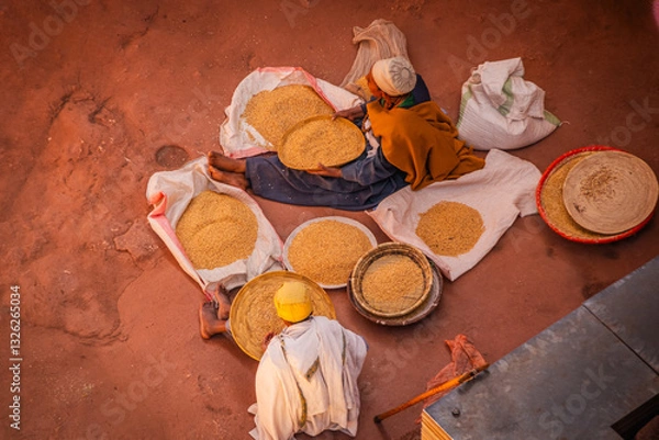 Fototapeta People sorting grain by a church in Lalibela, Ethiopia