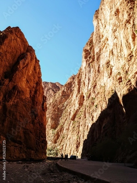 Obraz Scenic mountain gorge with steep rocky cliffs under a clear blue sky in Todra Gorge, Morocco