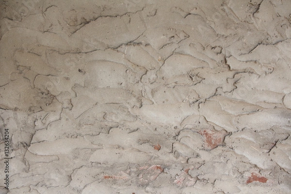 Fototapeta Gray wall covered with plaster. Rough uneven texture