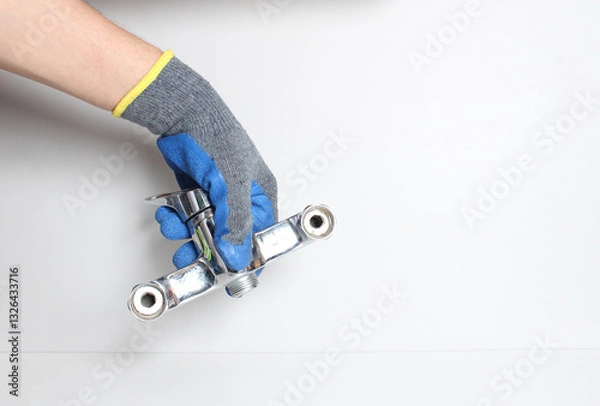 Obraz water tap in a hand in a blue glove