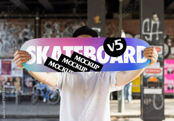 Fototapeta Mockup of a Skater holding a Skateboard Deck