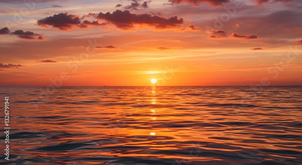 Obraz A stunning sunset over the ocean, with warm orange and pink hues reflecting on the water.