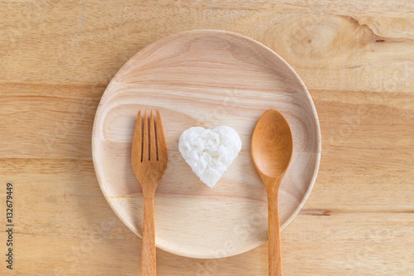 Fototapeta Heart shaped cooked rice in wooden plate.