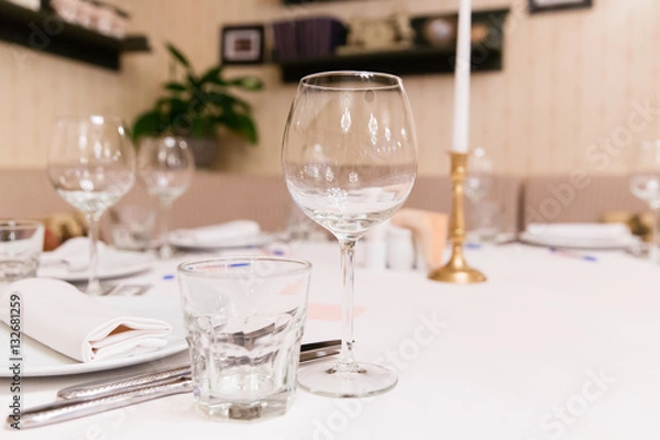 Fototapeta Restaurant table with empty glasses