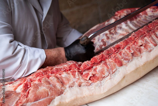 Fototapeta Butcher gesture in a butchery shop