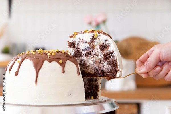 Fototapeta Taking a piece of cake with a spatula.