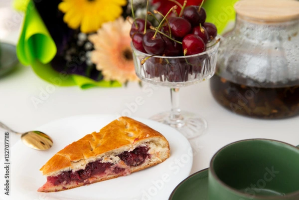 Fototapeta A piece of cherry pie lies on the table.