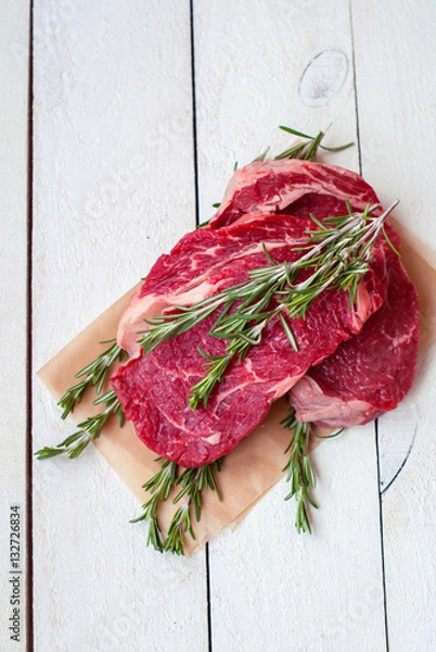 Fototapeta Beef raw steaks on a rough background