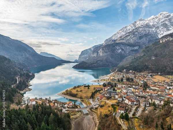 Fototapeta Aerial drone view of Lake Molveno, beautiful lake in Italy. Lake in dolomites from drone in winter. Lake Molveno in Italy. Sailboat, yacht on crystal clear lake in the Brenta Dolomites