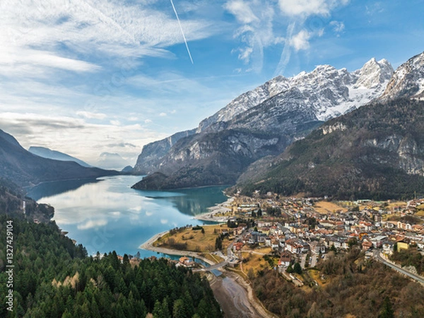 Fototapeta Aerial drone view of Lake Molveno, beautiful lake in Italy. Lake in dolomites from drone in winter. Lake Molveno in Italy. Sailboat, yacht on crystal clear lake in the Brenta Dolomites