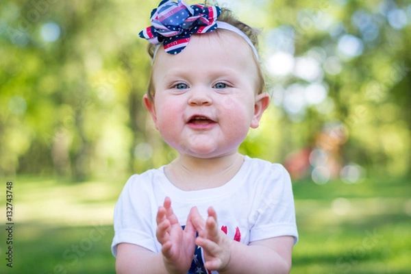 Obraz Festive one year old girl in the park on the 4th of July