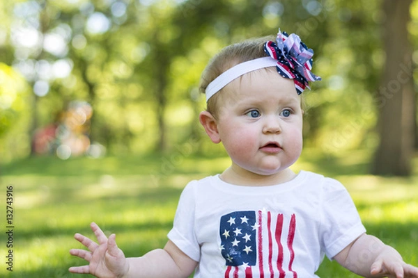 Obraz Festive one year old girl in the park on the 4th of July