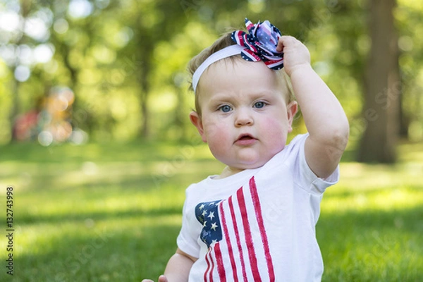Obraz Festive one year old girl in the park on the 4th of July
