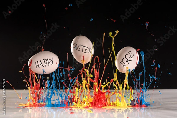 Fototapeta Easter eggs painted with coloured splash paint with text