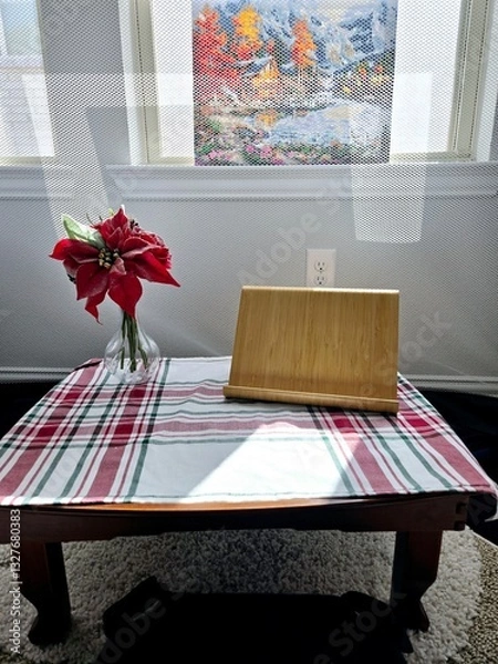 Fototapeta Sunlight gently streams through the window, casting a warm glow on the table,  capturing a sense of stillness and solitude.