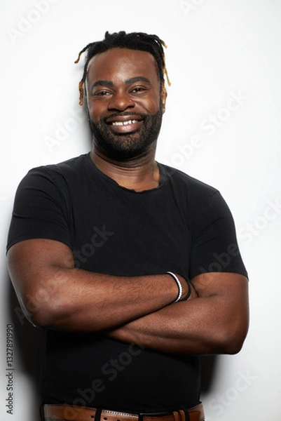Obraz Portrait of a confident Black man with well-groomed beard wearing a denim shirt against a white background