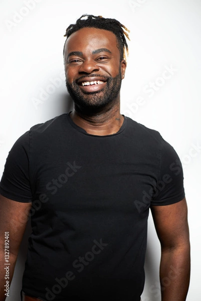 Obraz Portrait of a confident Black man with well-groomed beard wearing a denim shirt against a white background