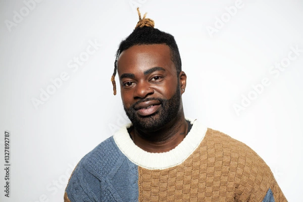 Obraz Portrait of a confident Black man with well-groomed beard wearing a denim shirt against a white background