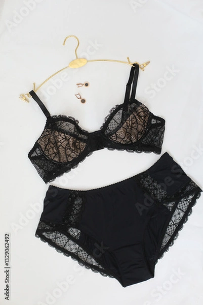 Fototapeta Woman's silk erotic lingerie on the white bed sheets. Valentine's day concept. Lace sexy female underwear. Beauty, fashion blogger concept. Female bra, panties, erotic clothes. Lingerie advertising