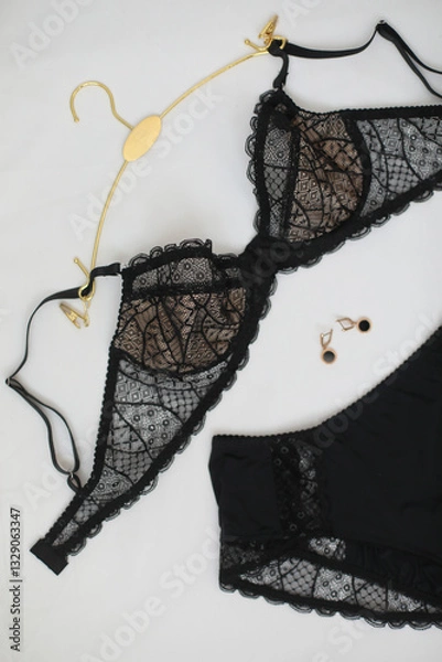Fototapeta Woman's silk erotic lingerie on the white bed sheets. Valentine's day concept. Lace sexy female underwear. Beauty, fashion blogger concept. Female bra, panties, erotic clothes. Lingerie advertising