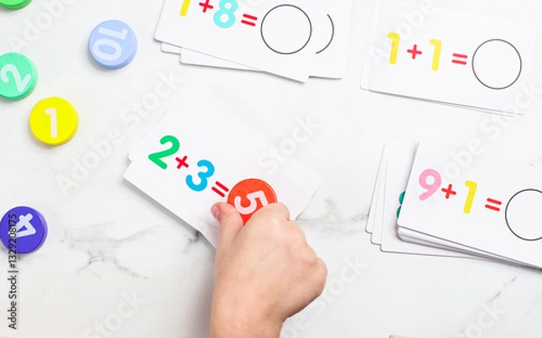 Fototapeta Engaging preschool children in fun mathematics activities using colorful cards and counters for early learning