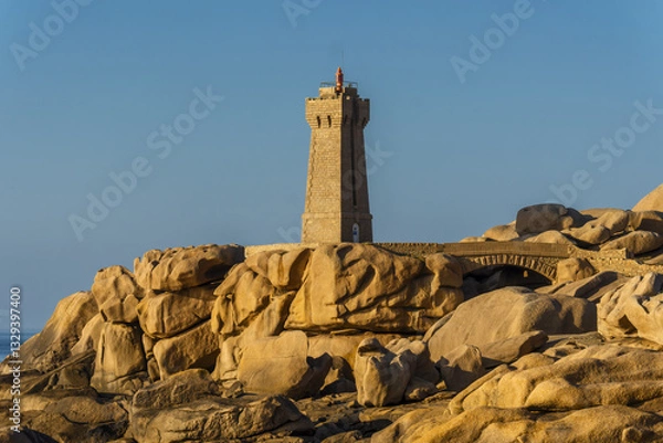 Obraz The Ploumanach Lighthouse officially the Mean Ruz Lighthouse located on a cape of pink granite rock located in Perros-Guirec, Côtes-d'Armor, France,