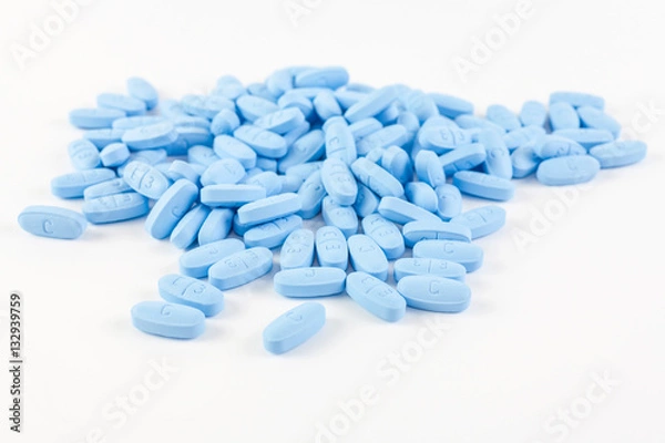Fototapeta Blue pills on white background
