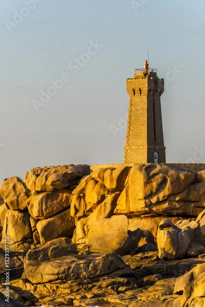 Obraz The Ploumanach Lighthouse officially the Mean Ruz Lighthouse located on a cape of pink granite rock located in Perros-Guirec, Côtes-d'Armor, France,
