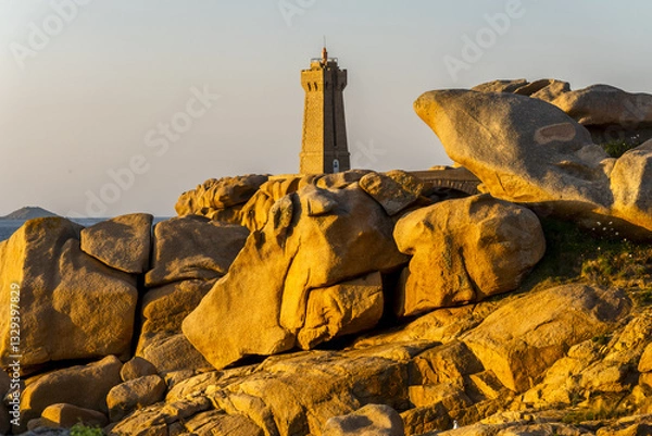 Obraz The Ploumanach Lighthouse officially the Mean Ruz Lighthouse located on a cape of pink granite rock located in Perros-Guirec, Côtes-d'Armor, France,