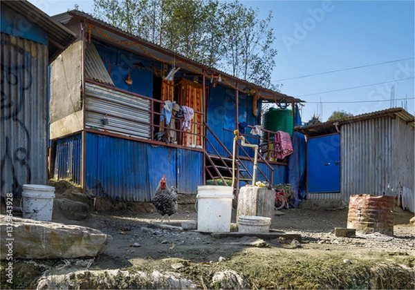 Obraz Local liveable shanty made of corrugated iron sheets next to a water pipe