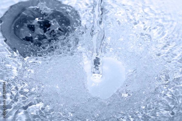 Fototapeta water running down in drain