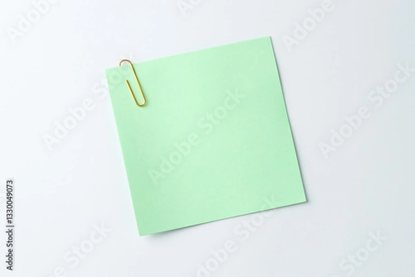Fototapeta Paper note with clip on light background, top view. Space for text