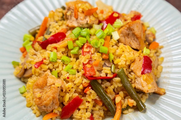 Fototapeta On a wooden table in a plate there are vegetables stewed