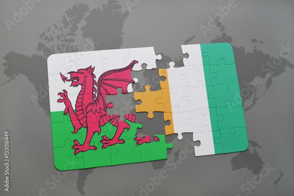 Fototapeta puzzle with the national flag of wales and cote divoire on a world map