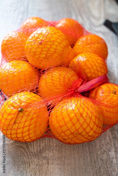 Fototapeta Fresh Oranges Packed in a Net Bag NutrientRich Healthy Fruits for Your Nutrition Needs