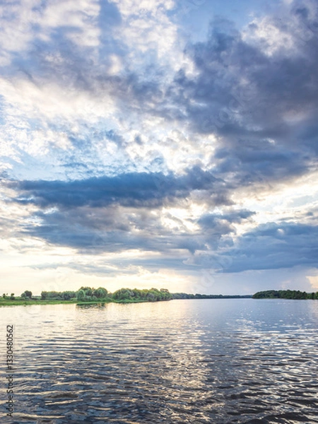 Fototapeta Cloudy sky with a lake in the background