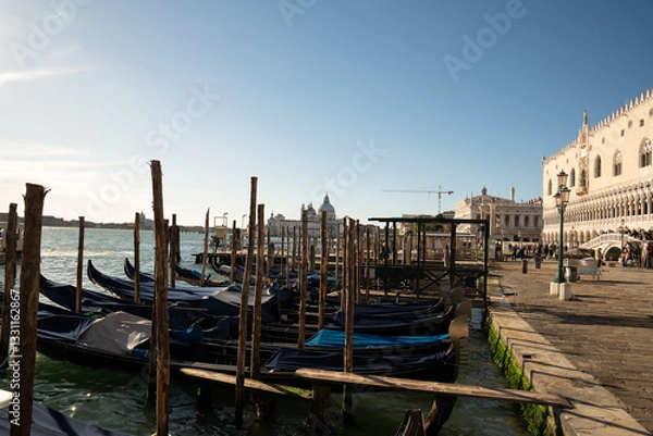 Obraz Traditional gondolas docked along the Grand Canal in Venice, Italy, with cityscape views.