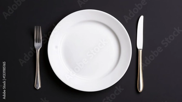 Fototapeta Elegant table setting with a white plate and silverware