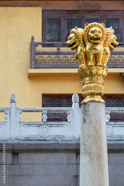 Fototapeta The Golden Lion Capital atop a Stone Column is beautifully set against a captivating backdrop