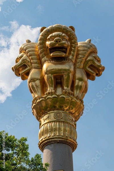 Fototapeta Golden Lion Capital majestically stands strong against the brilliant backdrop of the blue sky