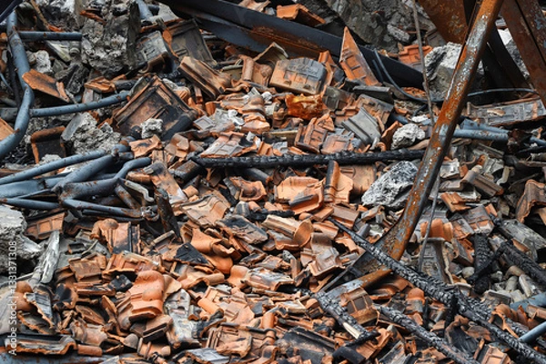 Fototapeta The debris from the roof of a building that fell and was destroyed, the debris consisted of tiles, wooden frames and iron supports that fell due to the building fire