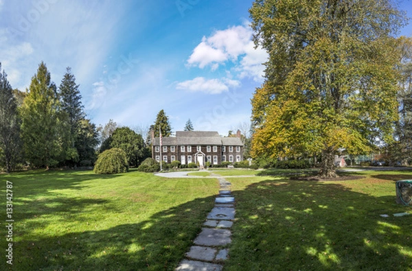 Fototapeta old victorian buildings in a green garden in East Hampton on a s