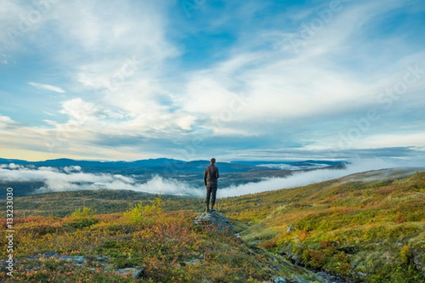 Fototapeta Man standing at scenic point in mountains