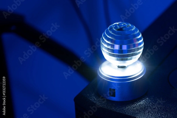 Obraz Small rotating disco ball in motion blur as effect light for nightlife events like club, disco or party, dark blue background, copy space, selected focus