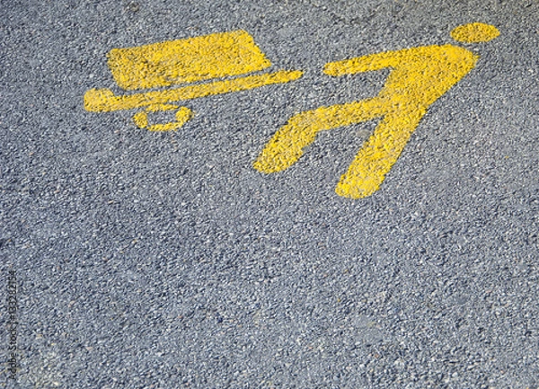 Fototapeta Yellow parking symbol for loading and unloading goods area on the ground, with copy space.