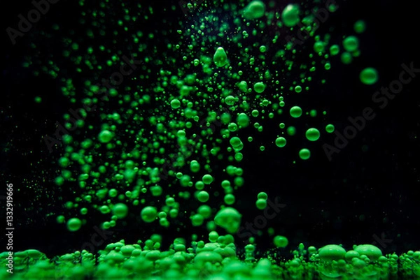 Obraz Green bubbles rise in a dark underwater environment creating a stunning visual display