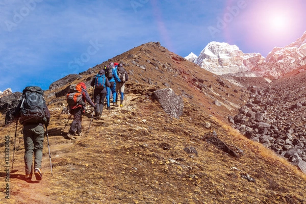 Obraz Mountaineering Expedition moving toward high Altitude Mountain Sunshine