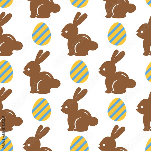 Fototapeta Easter seamless pattern with chocolate bunnies and yellow eggs on a white background. Pastel pattern with Easter rabbits. Cute background for greeting cards, baby textiles, wallpapers