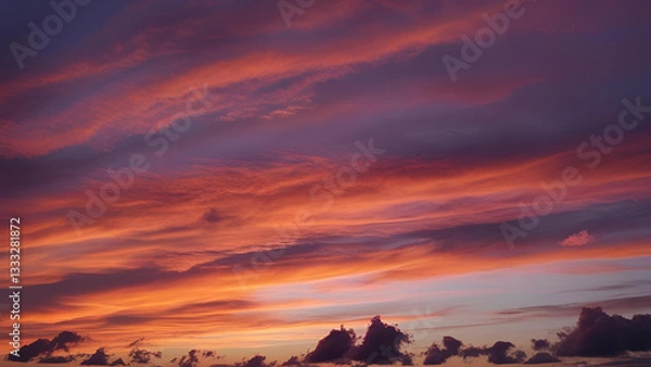 Obraz The sky is adorned with a breathtaking sunset, casting its glow over the clouds